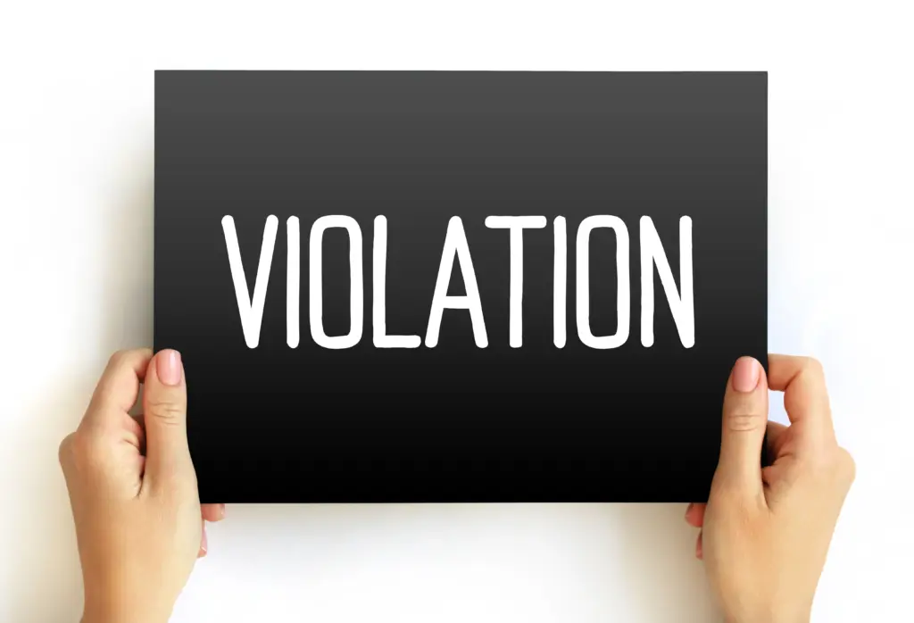 Hands holding sign with word violation