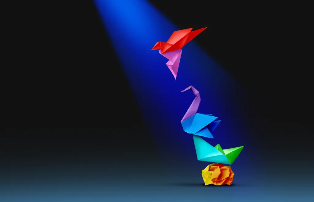 Colorful origami birds under blue spotlight