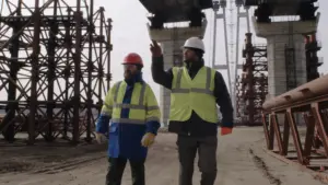Construction site with safety signage and workers following EM 385 protocols
