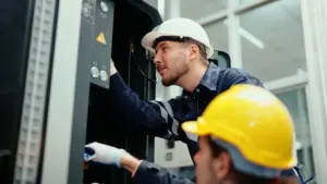 Engineers inspecting industrial electrical panel