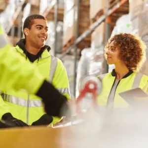 Warehouse workers discussing safety procedures