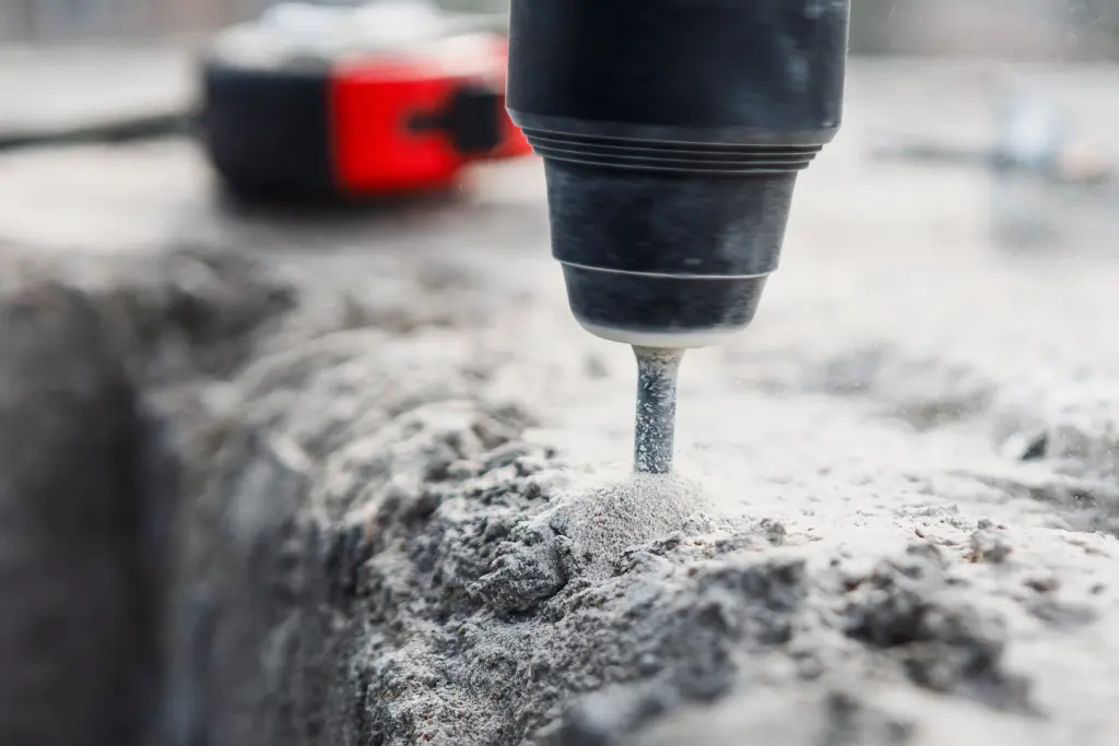 Power drill drilling into concrete surface