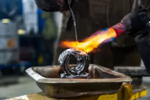 Metal part being heated with a torch