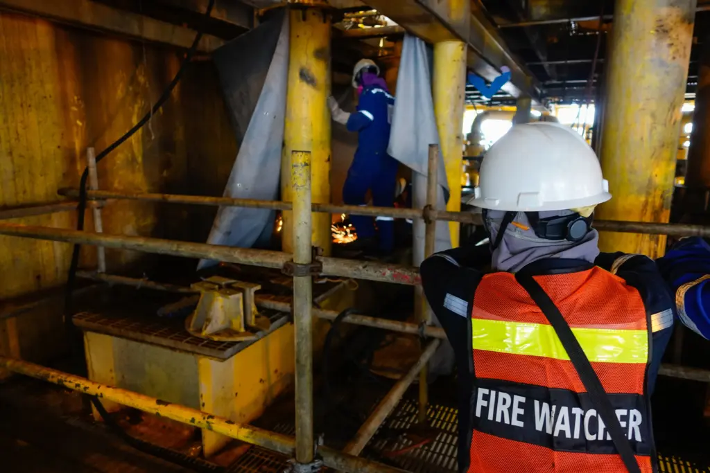 Firefighter gear stored on wooden station racks